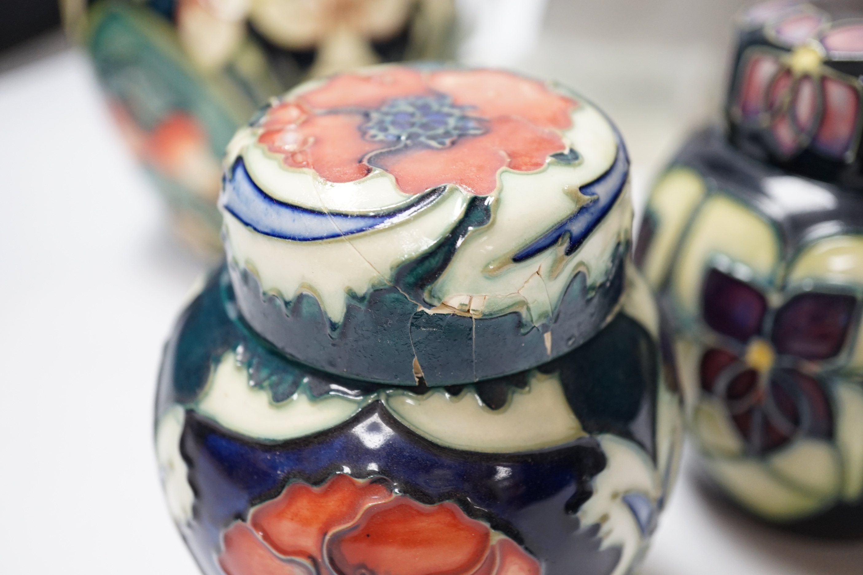 Four modern Moorcroft jars and covers, largest 16cm high, three boxed and a Nao figure group, tallest 95cm high